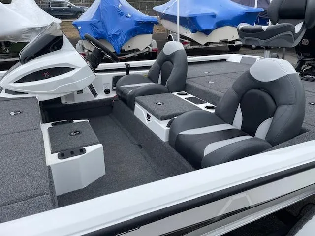 Slide: The Image of 2025 Vexus AVX V2 1880 boat interior with gray seating and storage compartments. - 8