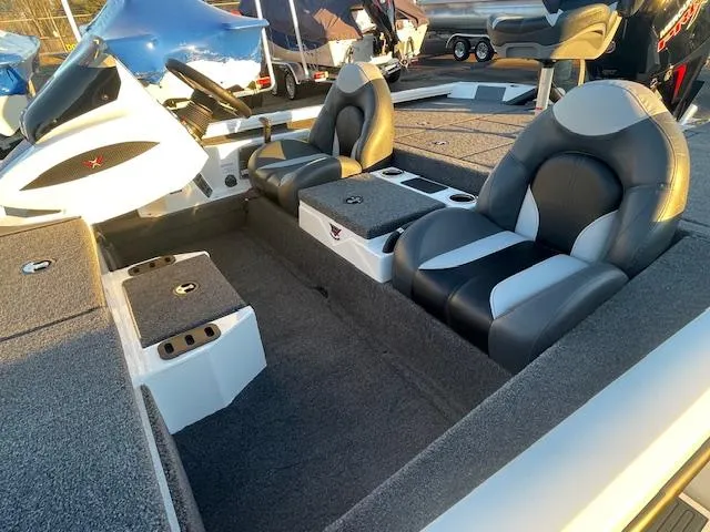 Slide: The Image of 2025 Vexus AVX V2 1880 boat interior with dual seats and storage compartments. - 9