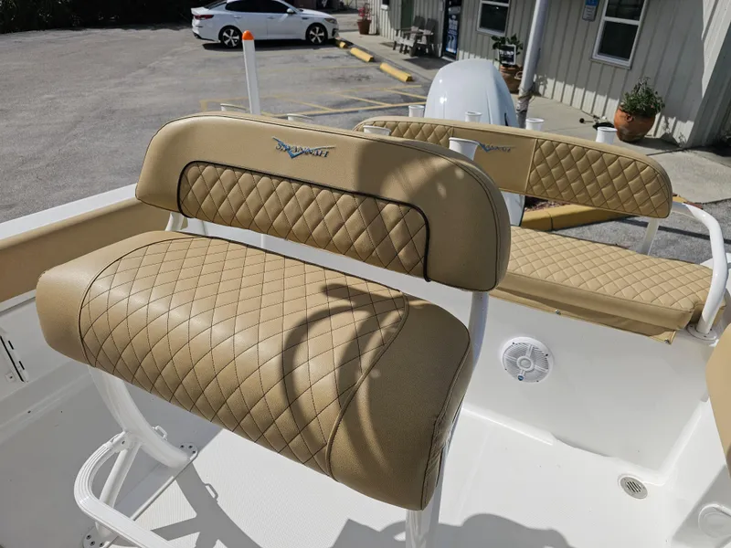 Slide: The Image of 2025 Savannah 2200 Offshore boat with tan quilted seating in a parking lot. - 13