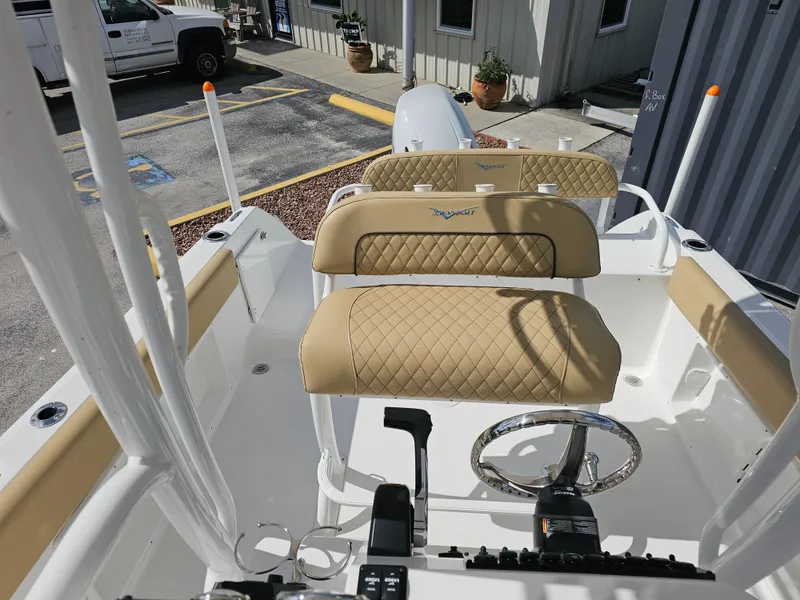 Slide: The Image of 2025 Savannah 2200 Offshore boat interior with tan quilted seats and steering wheel. - 23