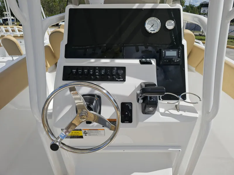 Slide: The Image of Control panel of 2025 Savannah 2200 Offshore boat with steering wheel and gauges. - 27