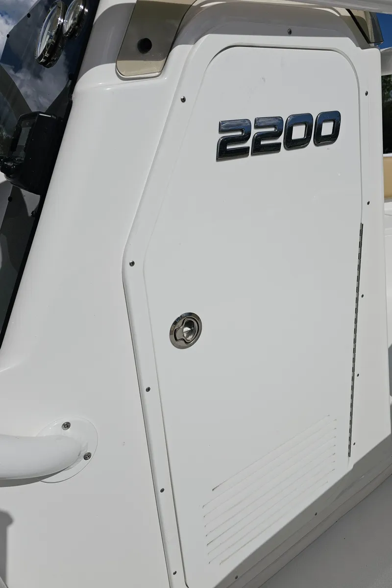 Slide: The Image of 2025 Savannah 2200 Offshore boat, white exterior, close-up view of side panel. - 37