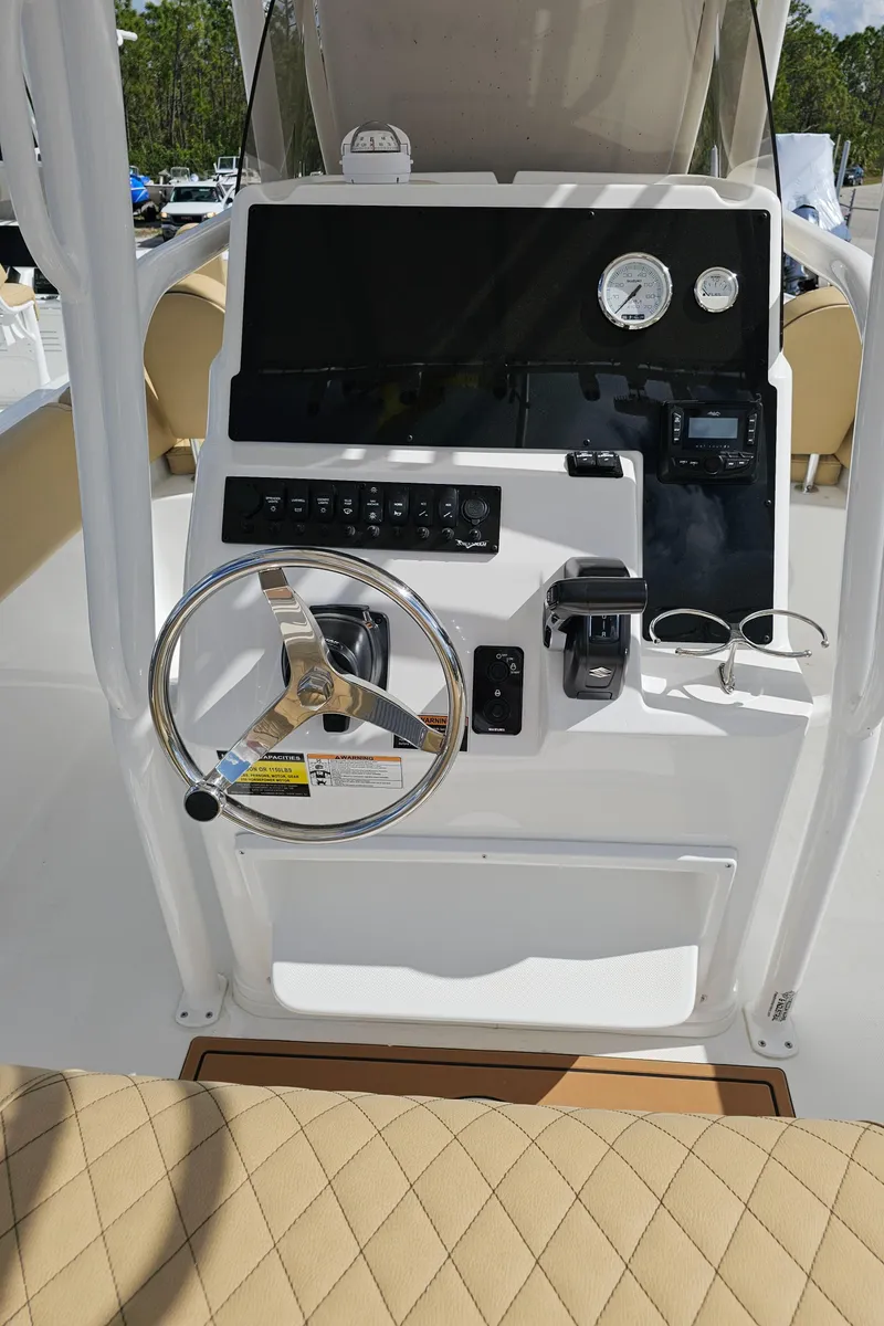 Slide: The Image of 2025 Savannah 2200 Offshore boat console with steering wheel and controls. - 40