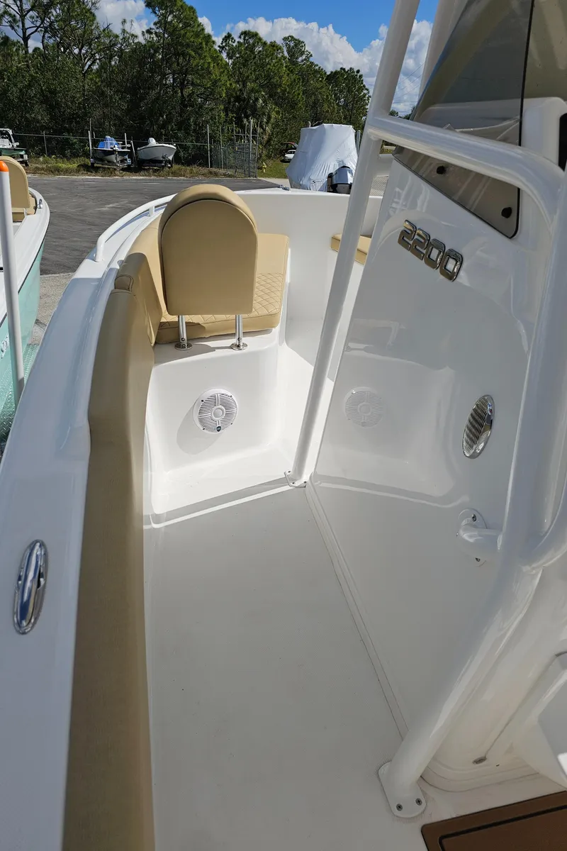 Slide: The Image of 2025 Savannah 2200 Offshore boat interior with beige seating and white deck. - 42