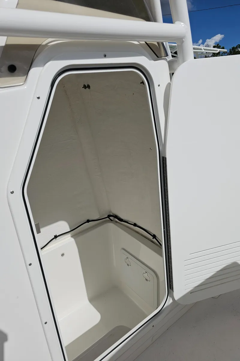 Slide: The Image of 2025 Savannah 2200 Offshore boat storage compartment with open hatch, showcasing interior space. - 45