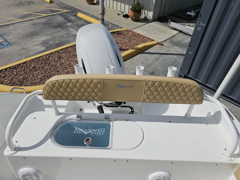 Slide: The Image of 2025 Savannah 2200 Offshore boat interior with cushioned seating and rod holders. - 9