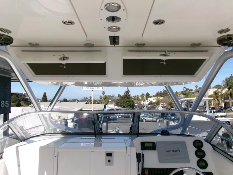 Slide: The Image of 2016 Sea Fox 256 Voyager boat cockpit with Garmin navigation system and overhead storage. - 17