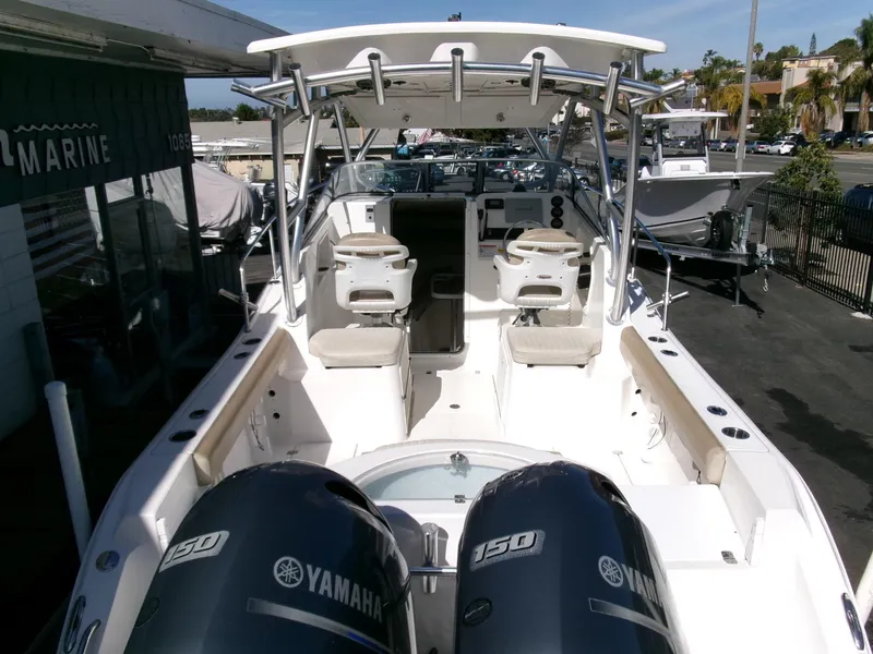 Slide: The Image of 2016 Sea Fox 256 Voyager boat with dual Yamaha 150 engines, docked at a marina. - 28
