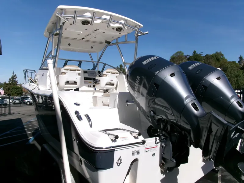 Slide: The Image of 2016 Sea Fox 256 Voyager boat with dual outboard engines, docked under clear blue sky. - 3