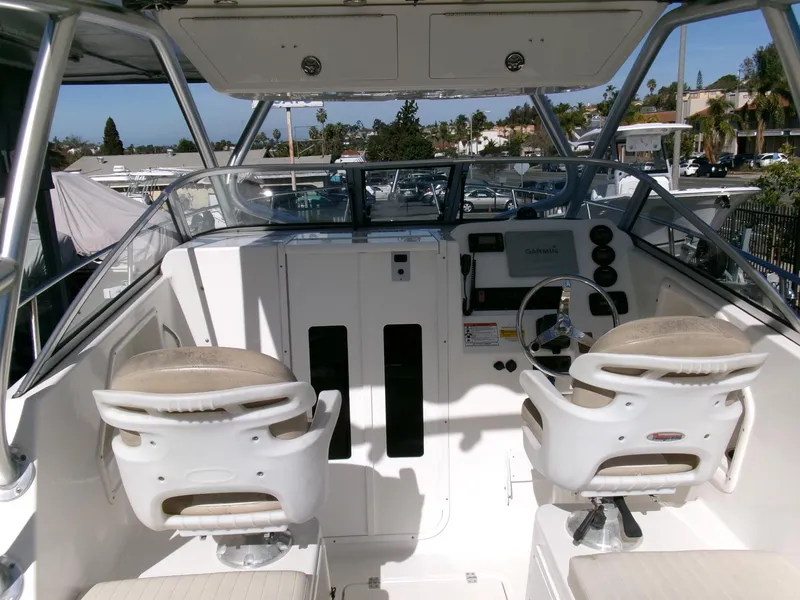 Slide: The Image of 2016 Sea Fox 256 Voyager boat cockpit with dual seats and steering console. - 6