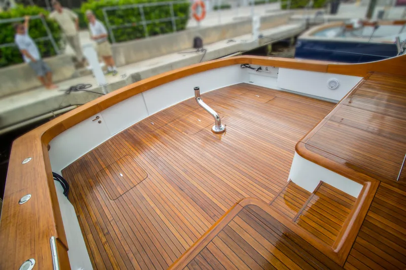 Slide: The Image of Teak deck of 2000 Merritt 80' Sportfish boat, docked with polished wood finish. - 10