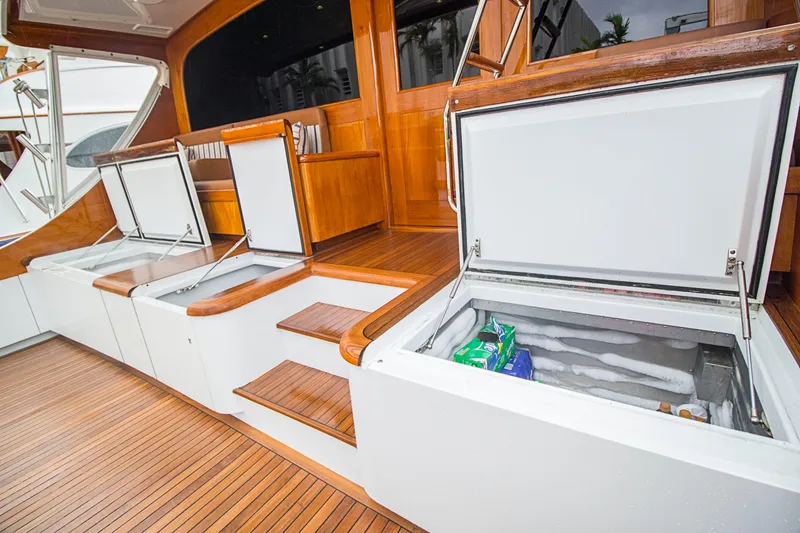 Slide: The Image of Open storage compartments on 2000 Merritt 80' Sportfish yacht deck with wooden flooring. - 12
