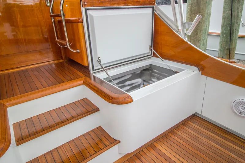 Slide: The Image of Open storage compartment on 2000 Merritt 80' Sportfish boat with wooden deck. - 14