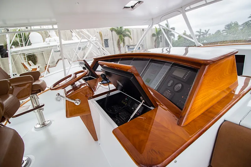 Slide: The Image of Helm of 2000 Merritt 80' Sportfish with polished wood and modern controls. - 16