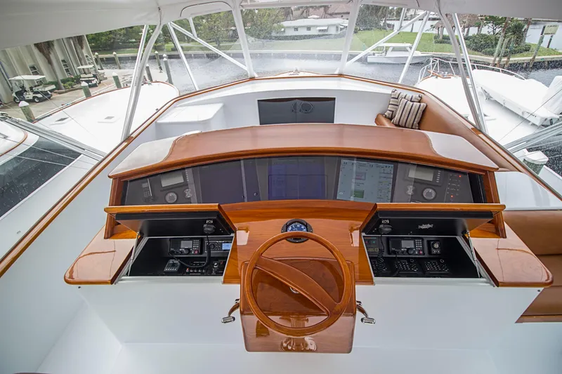 Slide: The Image of Cockpit of 2000 Merritt 80' Sportfish yacht with wooden steering wheel and navigation equipment. - 18