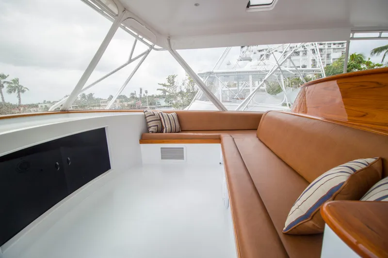 Slide: The Image of Interior of 2000 Merritt 80' Sportfish yacht with brown leather seating and striped cushions. - 20
