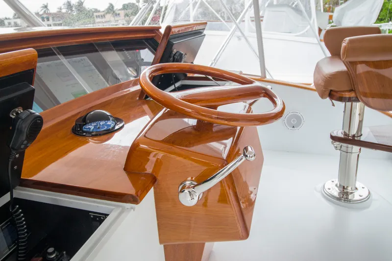 Slide: The Image of Steering wheel of 2000 Merritt 80' Sportfish yacht with wooden finish. - 23
