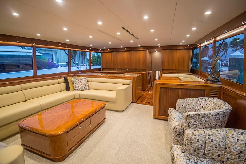 Slide: The Image of Luxurious interior of a 2000 Merritt 80' Sportfish yacht with elegant seating and wood finishes. - 26
