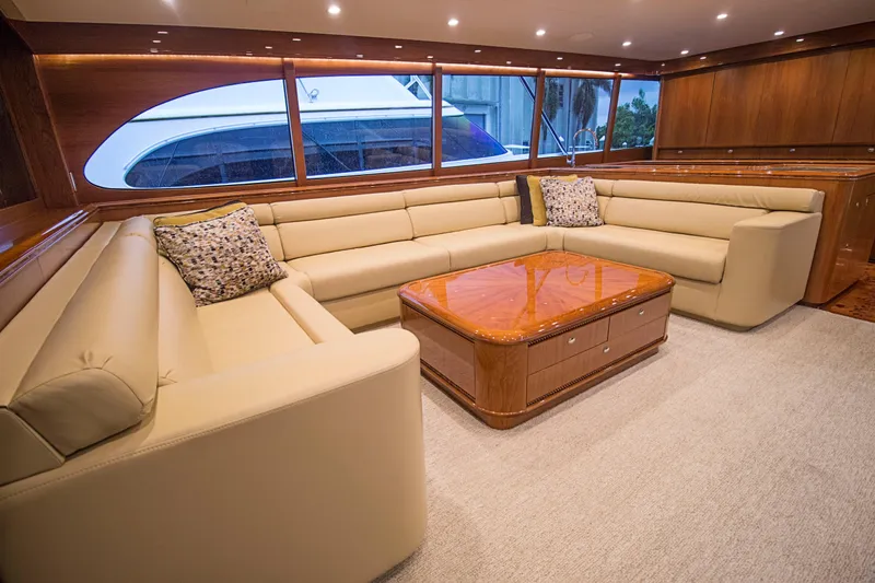 Slide: The Image of Luxurious interior of 2000 Merritt 80' Sportfish yacht with beige leather seating and wooden table. - 27