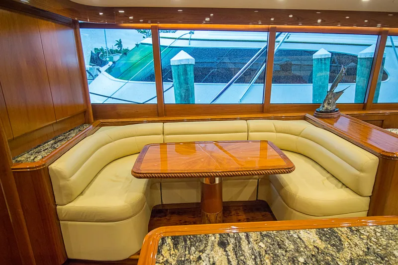 Slide: The Image of Luxurious Merritt 80' Sportfish 2000 yacht interior with elegant seating and wooden table. - 29