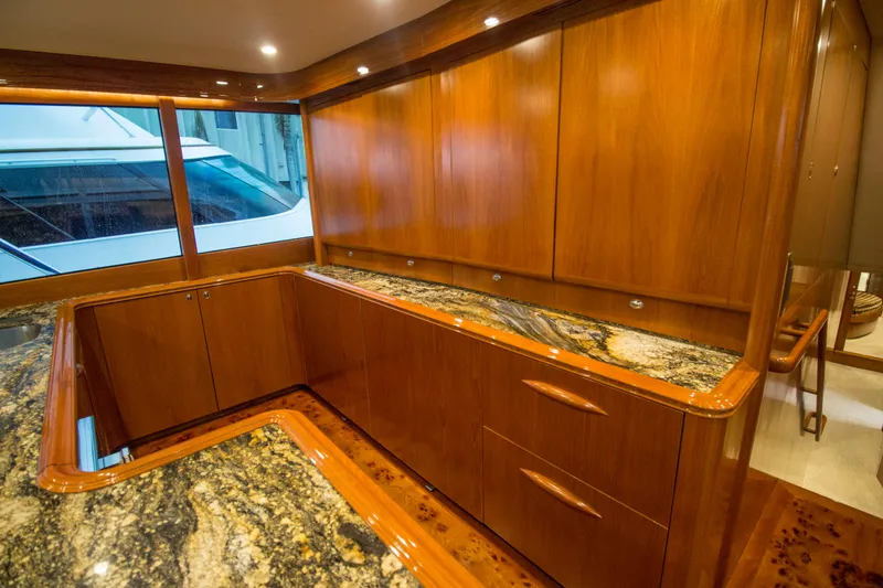 Slide: The Image of Luxurious wooden interior of a 2000 Merritt 80' Sportfish yacht with granite countertops. - 33