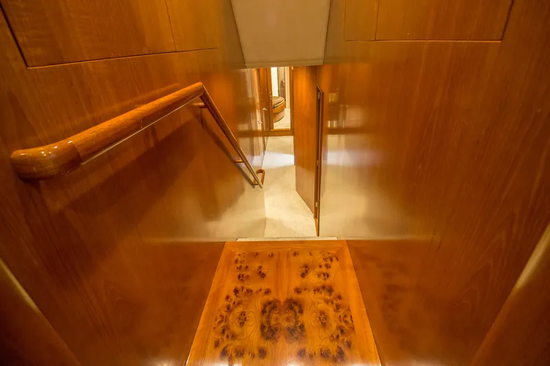Slide: The Image of Interior of 2000 Merritt 80' Sportfish yacht with polished wood staircase and handrail. - 39
