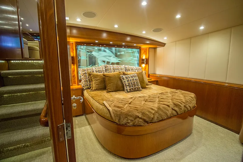 Slide: The Image of Luxurious bedroom interior of 2000 Merritt 80' Sportfish yacht with plush bedding and wood accents. - 41
