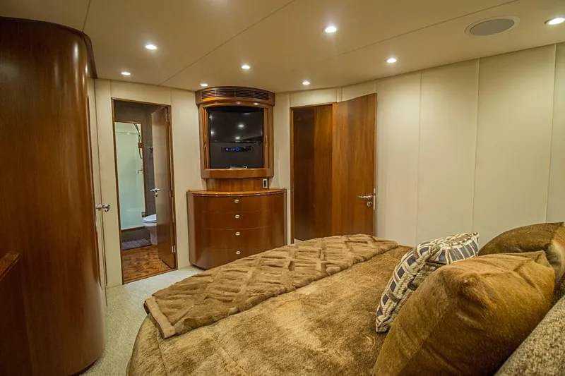 Slide: The Image of Luxurious bedroom interior of 2000 Merritt 80' Sportfish yacht with elegant wood finishes. - 43
