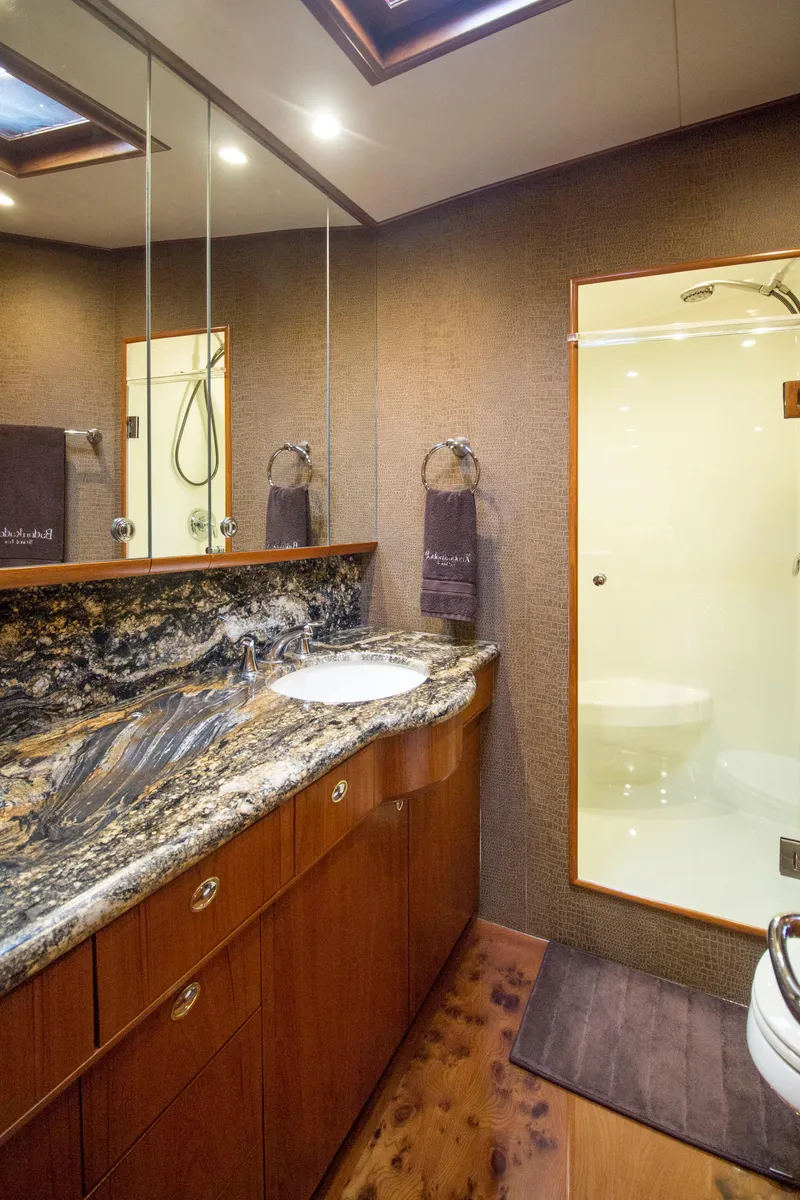 Slide: The Image of Luxurious bathroom in 2000 Merritt 80' Sportfish yacht with granite countertop and glass shower. - 44