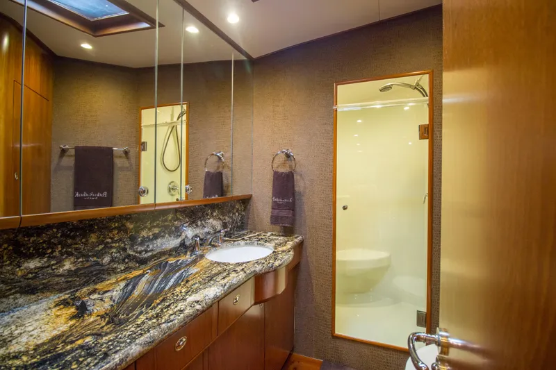 Slide: The Image of Luxurious bathroom on 2000 Merritt 80' Sportfish yacht with granite countertop and glass shower. - 45