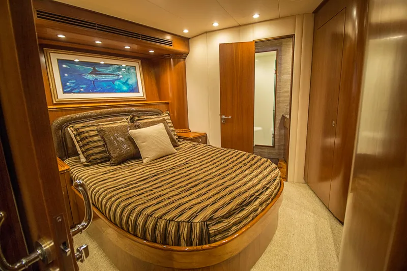 Slide: The Image of Luxurious bedroom interior on 2000 Merritt 80' Sportfish yacht with elegant wood finishes. - 46