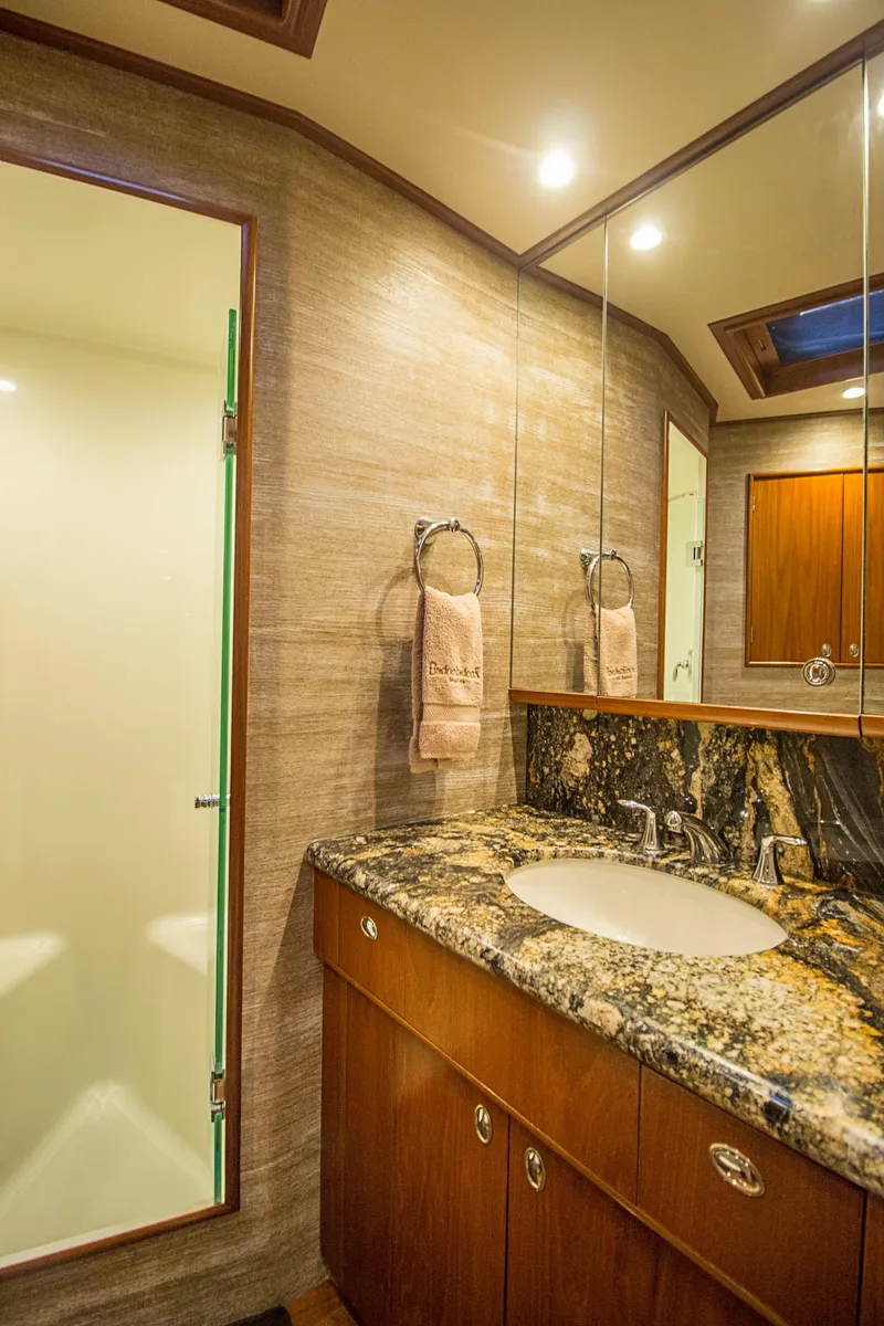 Slide: The Image of Luxurious bathroom in 2000 Merritt 80' Sportfish yacht with granite countertop and modern fixtures. - 49
