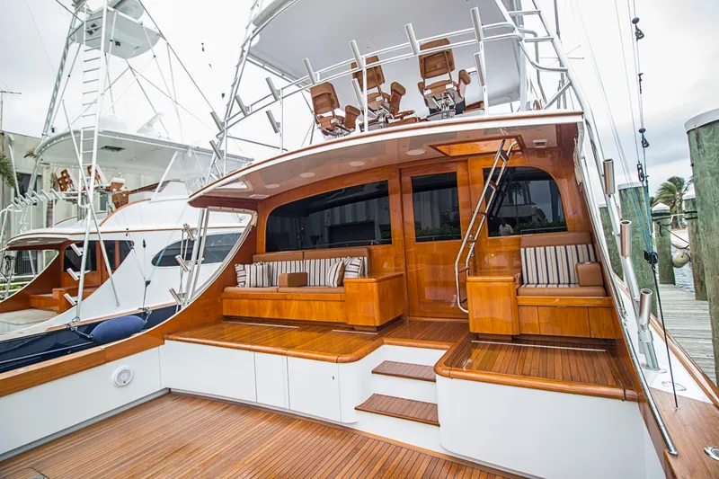 Slide: The Image of 2000 Merritt 80' Sportfish yacht with polished wood deck and seating area. - 5