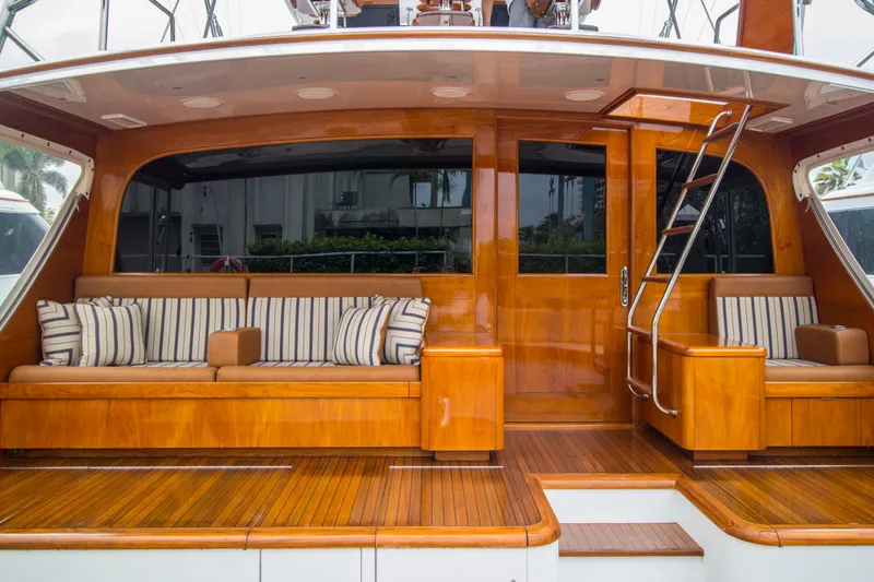 Slide: The Image of Luxurious Merritt 80' Sportfish yacht interior with wooden finish and striped seating, 2000 model. - 6