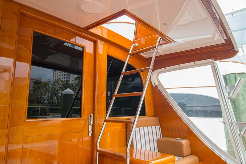 Slide: The Image of Interior view of 2000 Merritt 80' Sportfish yacht with wooden finish and ladder. - 8