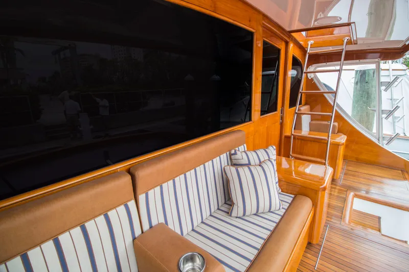 Slide: The Image of Luxurious Merritt 80' Sportfish yacht interior with striped seating, wooden finish, and ladder, 2000 model. - 9