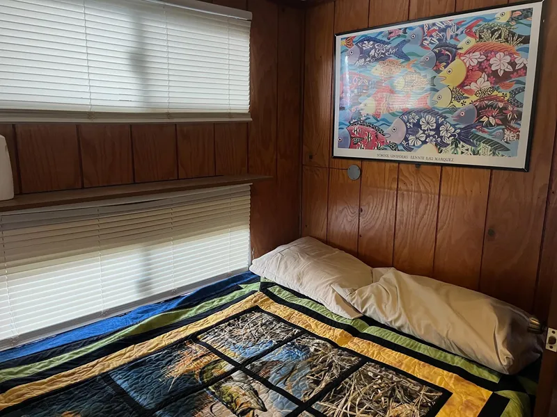 Slide: The Image of Cozy bedroom in 1986 Waterhouse 14 X 44 houseboat with colorful quilt and wall art. - 12