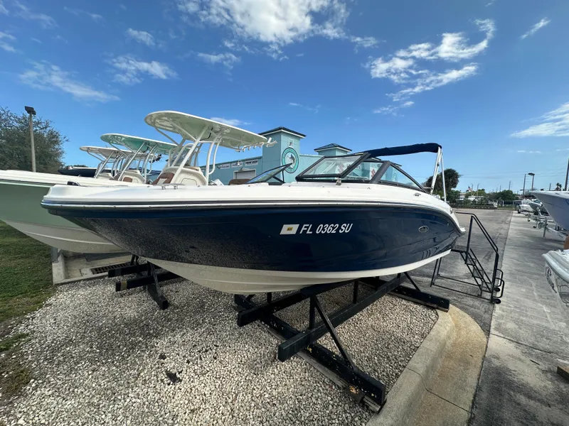 Slide: The Image of 2021 Sea Ray SPX 190 OB boat displayed on a stand under a clear sky. - 1
