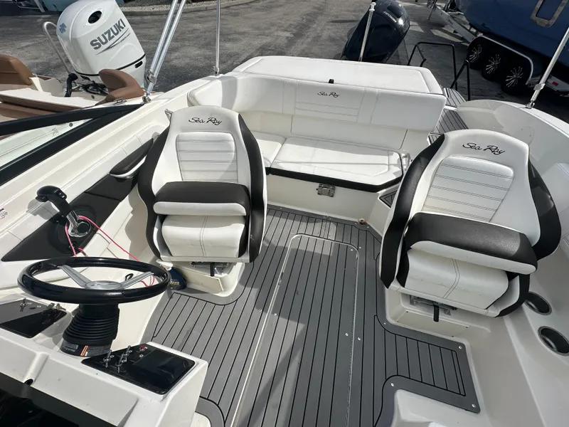 Slide: The Image of 2021 Sea Ray SPX 190 OB boat interior with white seating and gray flooring. - 10