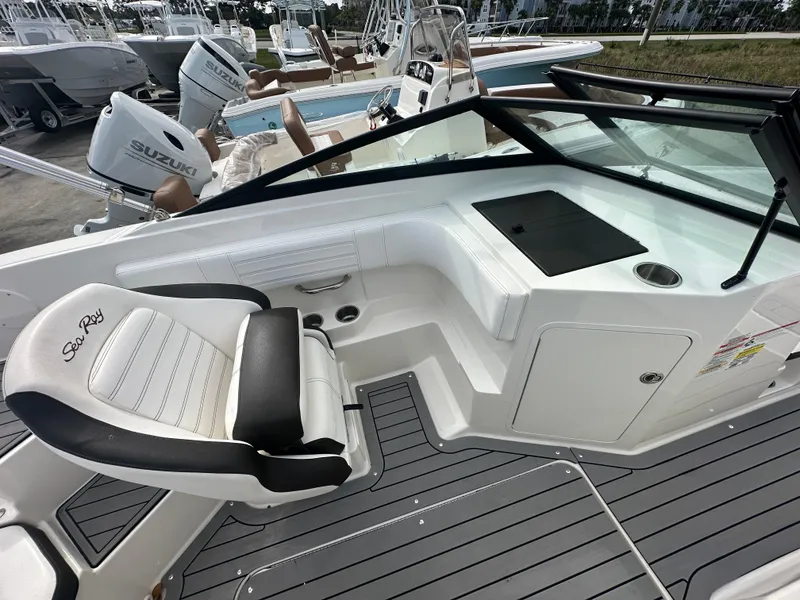 Slide: The Image of 2021 Sea Ray SPX 190 OB boat interior with seating and dashboard. - 11