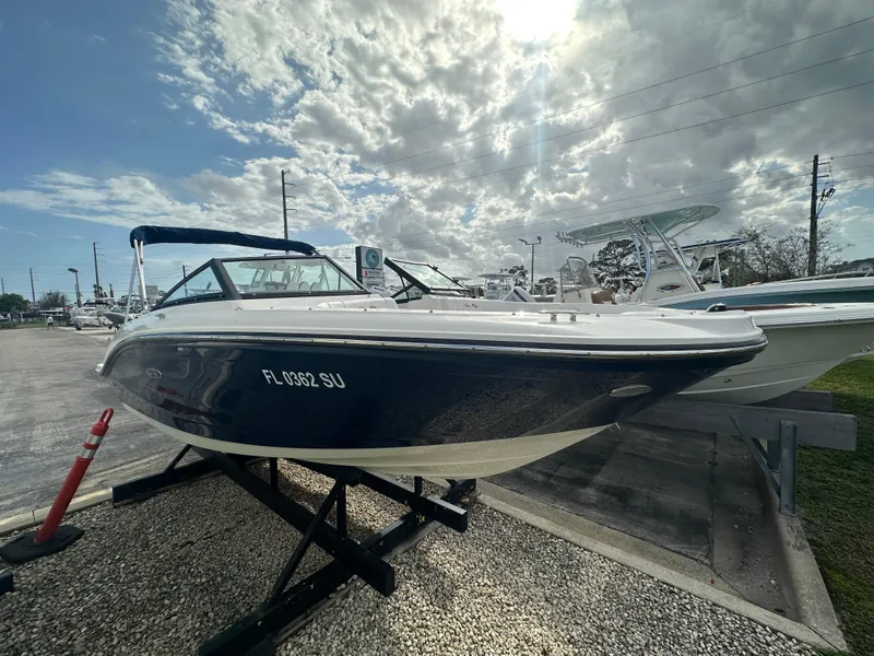 Slide: The Image of 2021 Sea Ray SPX 190 OB boat displayed outdoors under a cloudy sky. - 2