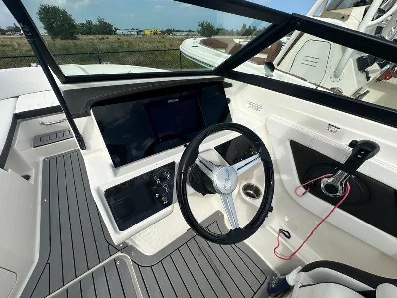 Slide: The Image of 2021 Sea Ray SPX 190 OB boat dashboard with steering wheel and control panel. - 5