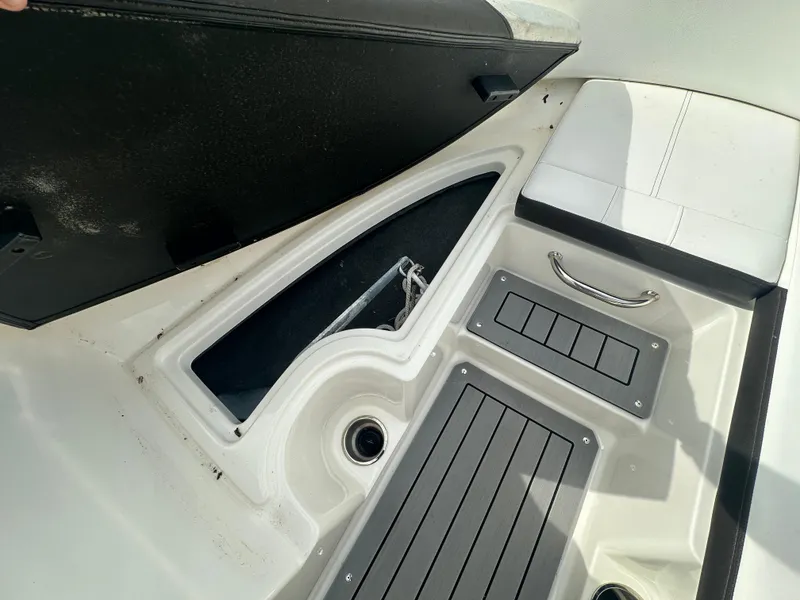 Slide: The Image of 2021 Sea Ray SPX 190 OB boat interior storage compartment with anchor and seating area. - 7