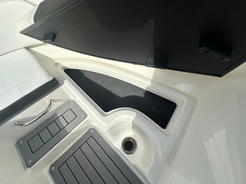 Slide: The Image of 2021 Sea Ray SPX 190 OB boat interior storage compartment and flooring detail. - 8