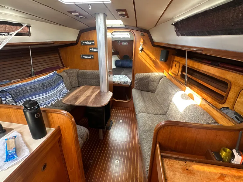 Slide: The Image of Interior of 1986 Beneteau First 375 sailboat with cozy seating and wooden finishes. - 10