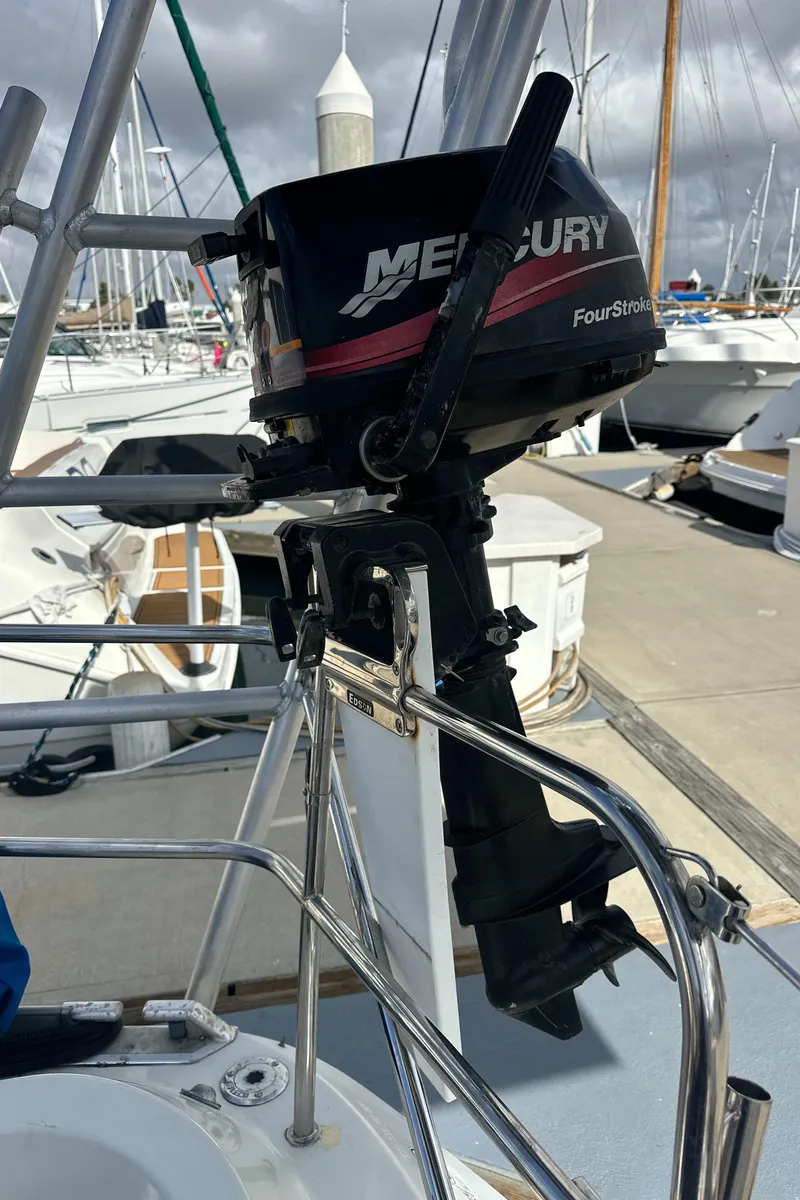 Slide: The Image of Outboard motor on a 1986 Beneteau First 375 sailboat at a marina. - 12