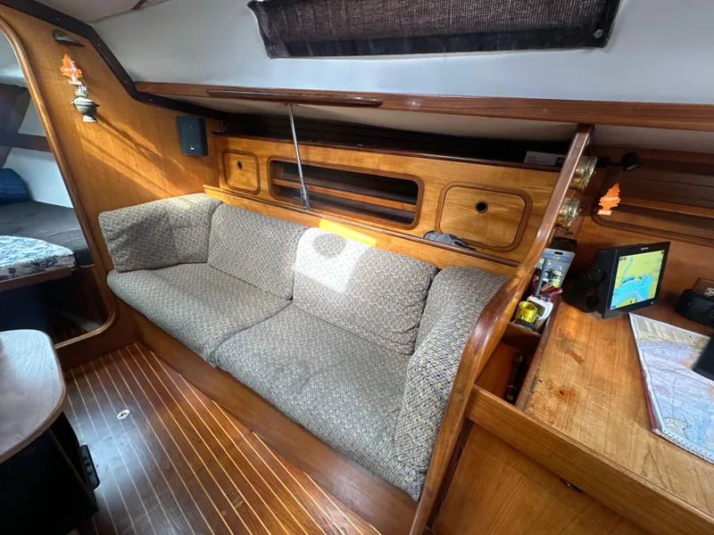 Slide: The Image of Interior of 1986 Beneteau First 375 sailboat with cozy seating and wooden finishes. - 15