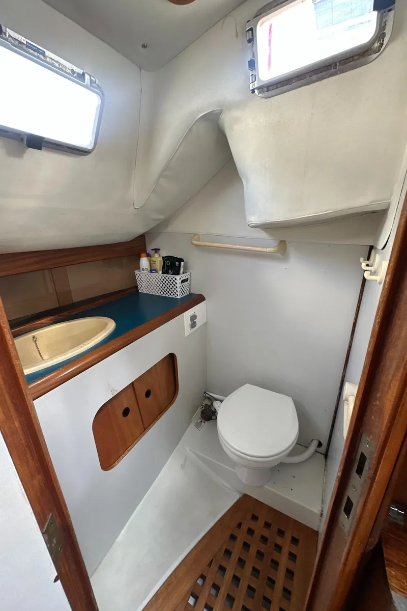 Slide: The Image of 1986 Beneteau First 375 yacht bathroom with sink, toilet, and storage. - 16