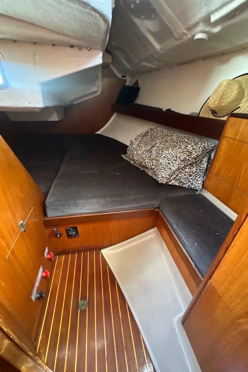 Slide: The Image of Cozy cabin interior of 1986 Beneteau First 375 sailboat with wooden accents and cushions. - 18