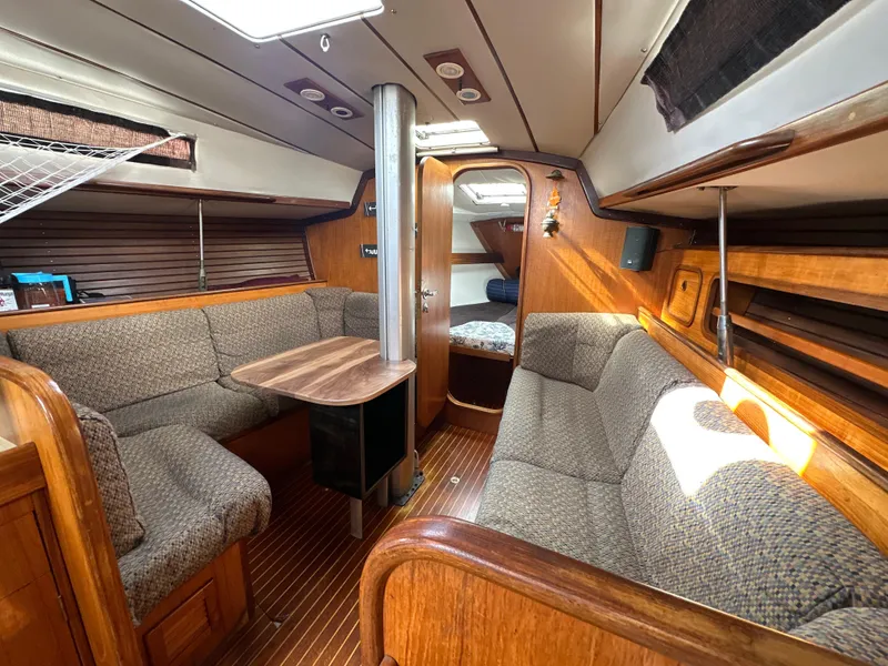 Slide: The Image of Interior of 1986 Beneteau First 375 sailboat with cozy seating and wooden finishes. - 24